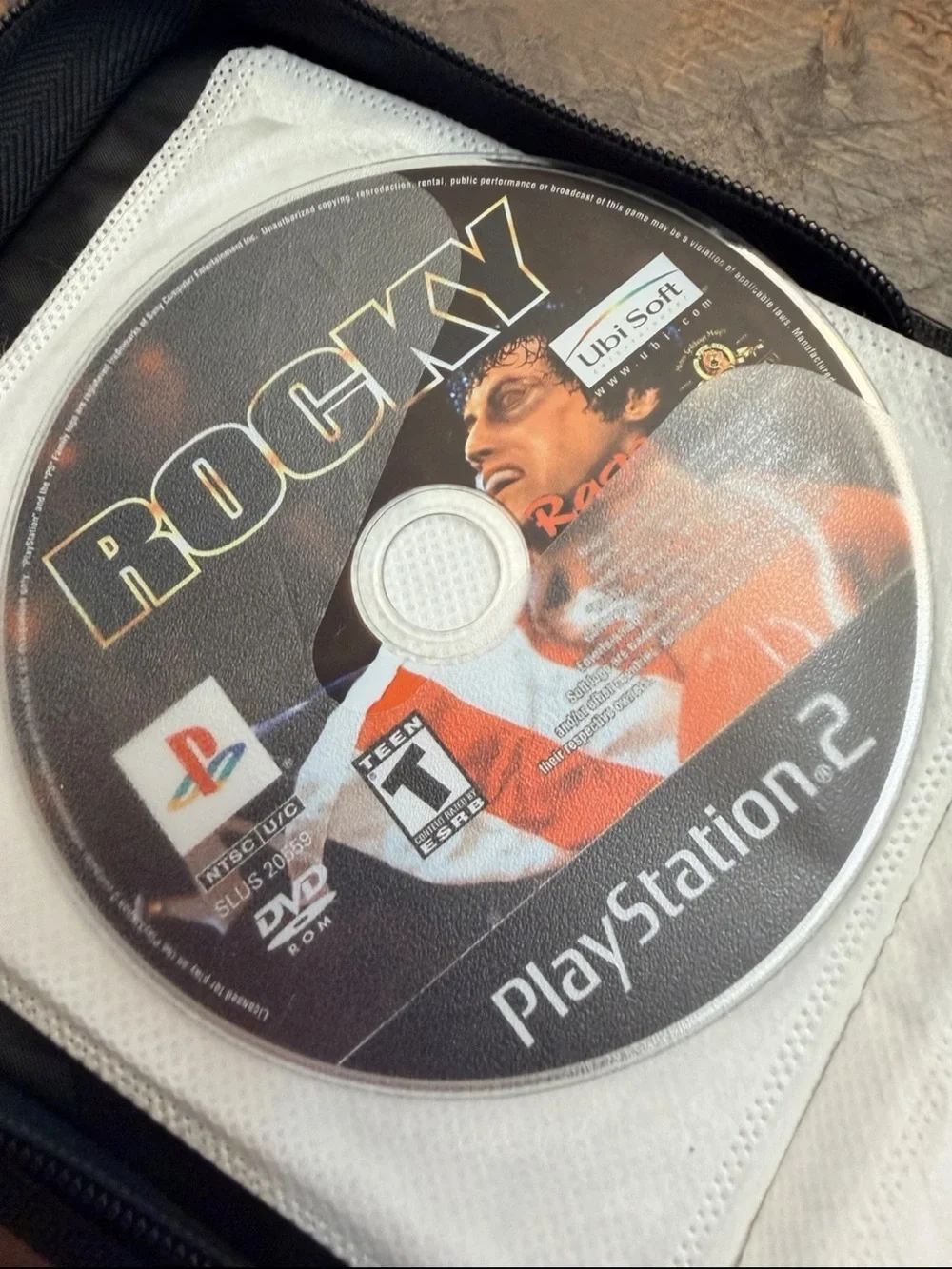 13 Disc Lot: 11 PS1 / Sony PS2 Games + 2 DVDs in Green Storage Binder Case